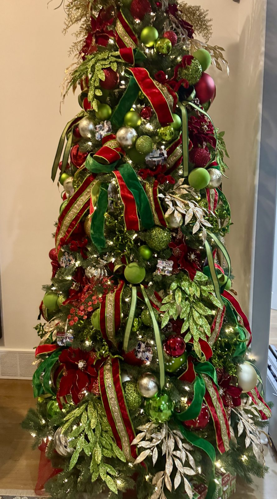 Classic red and green tree with velvet ribbon and glitter foliage
