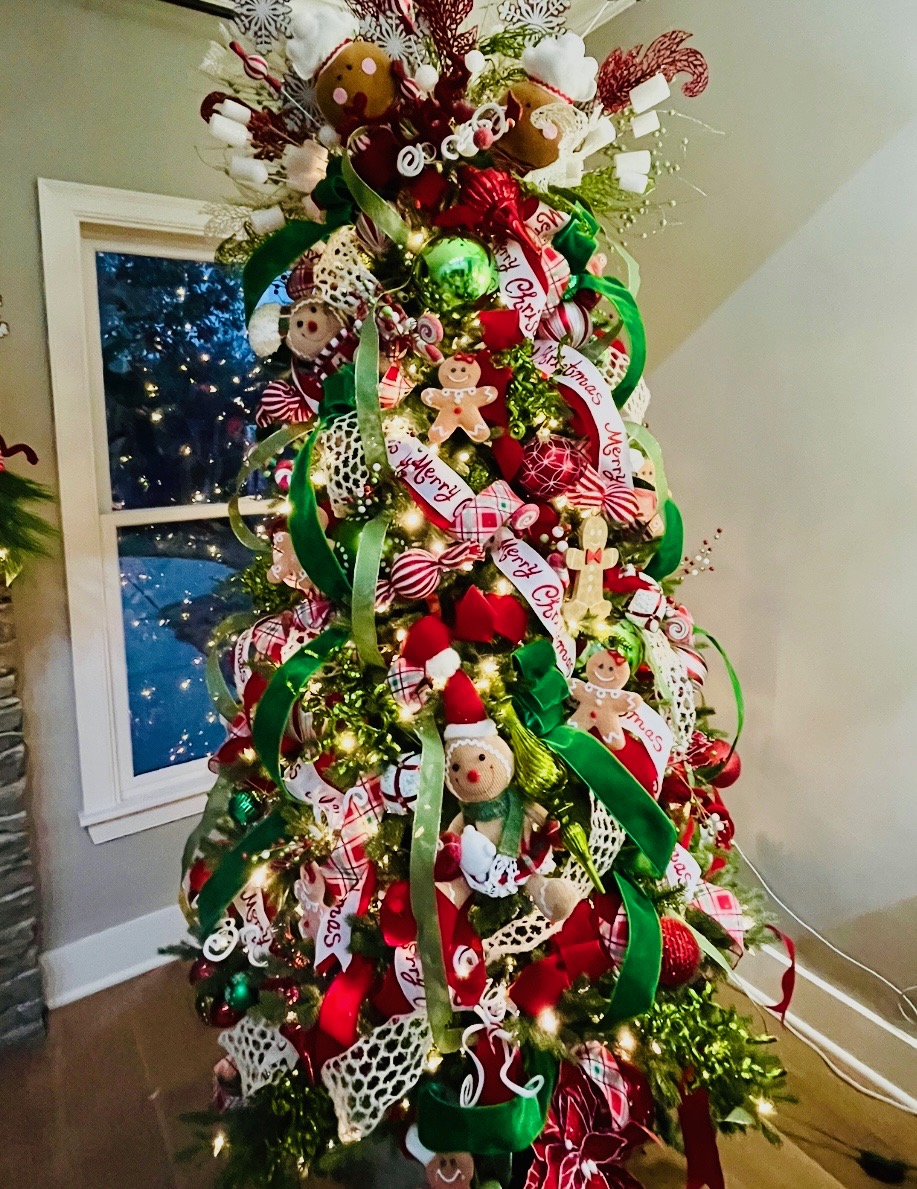 Classic red and green gingerbread tree with Merry Christmas ribbon