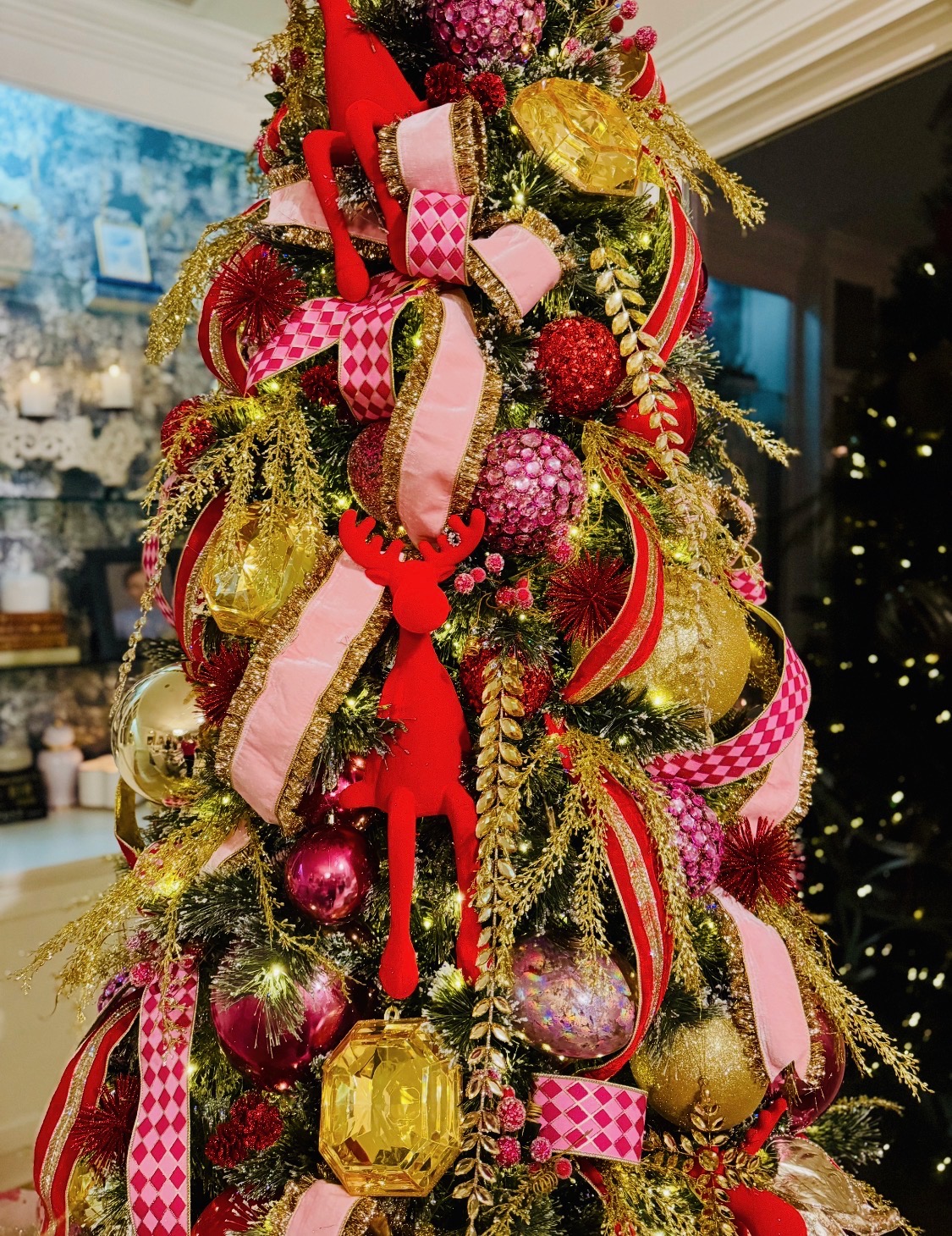 Red, pink and gold Christmas tree with harlequin ribbon and jewel ornaments